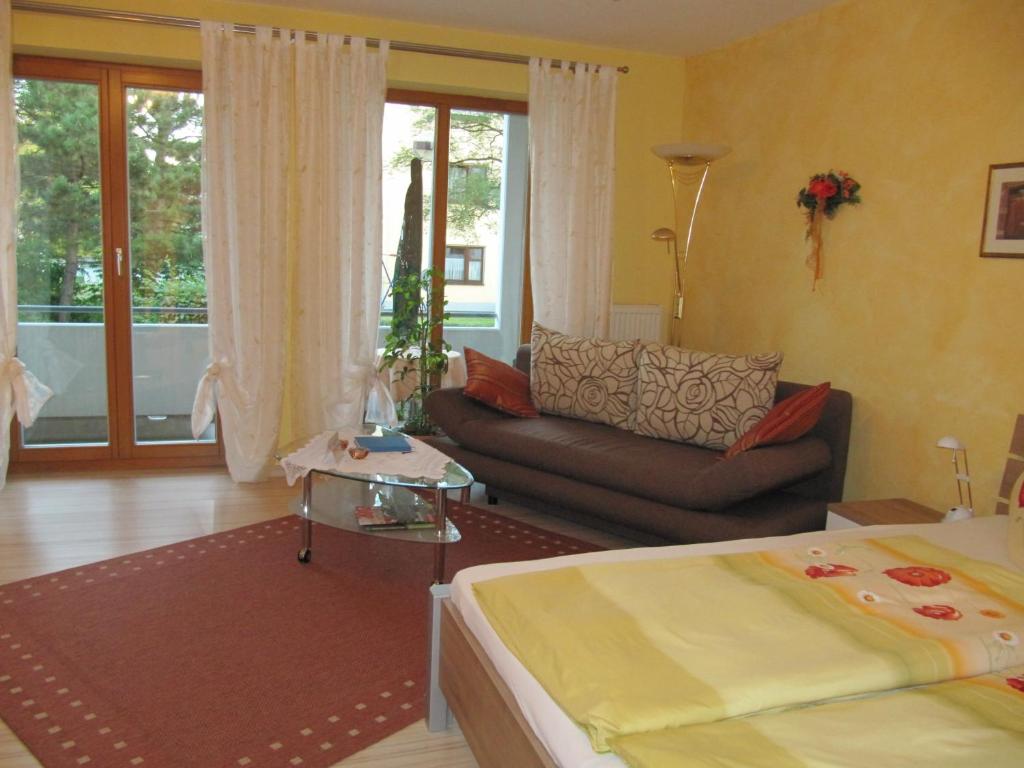 a living room with a bed and a couch at Apartment Abendstille mit Balkon und TG in Bamberg