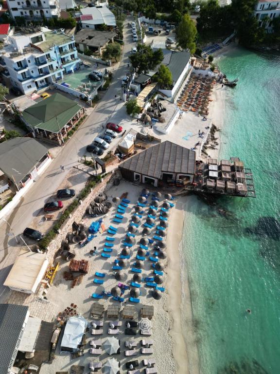 an aerial view of a beach with chairs and umbrellas at Hotel Esmerald Ksamil in Ksamil