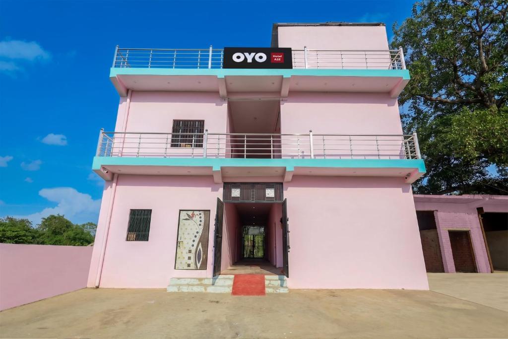 a pink building with a sign on it at Hotel O A2Z Hotel in Lucknow