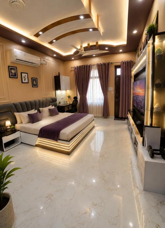 a large bedroom with a large bed and a tv at Countrysidecharm in Gwalior