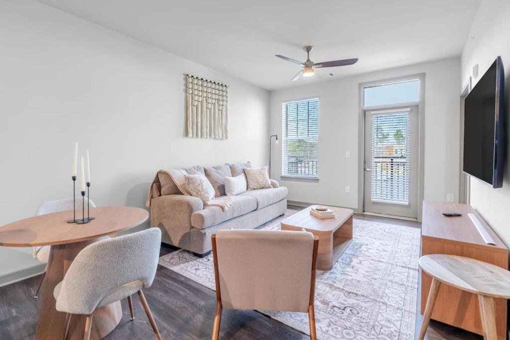 a living room with a couch and a table at Warm, Inviting 2BD Apt In Matthews in Charlotte