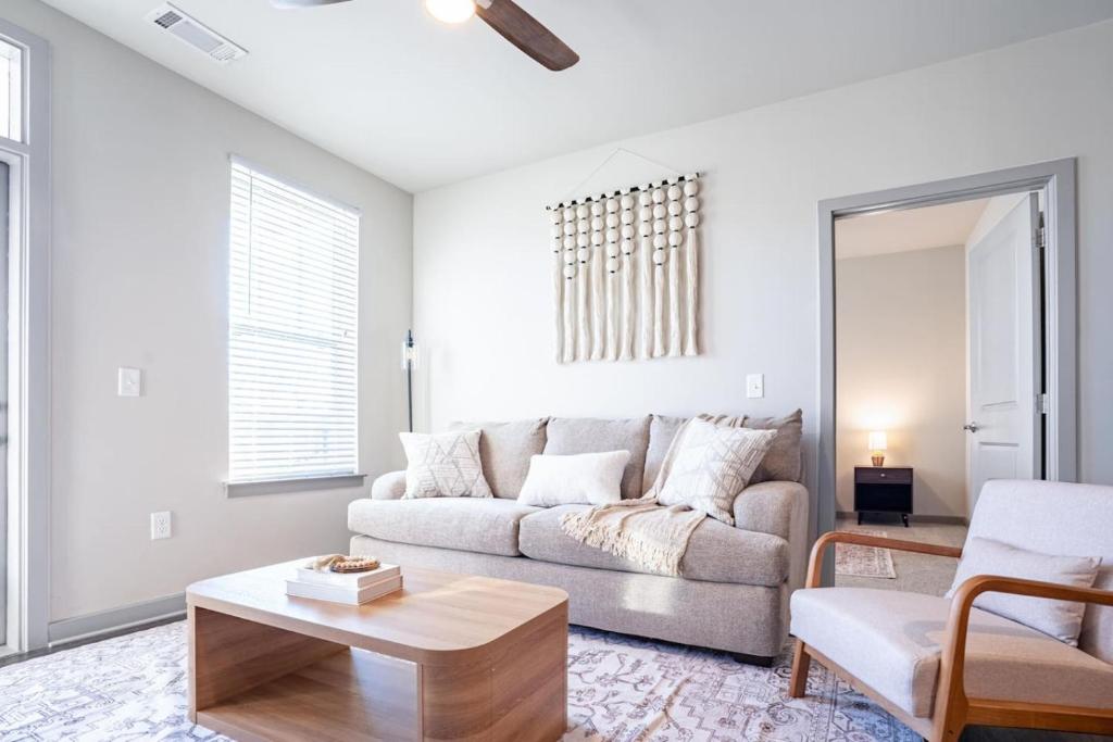 a living room with a couch and a table at Stylish, Comfortable 2BD Abode near DT Matthews in Charlotte