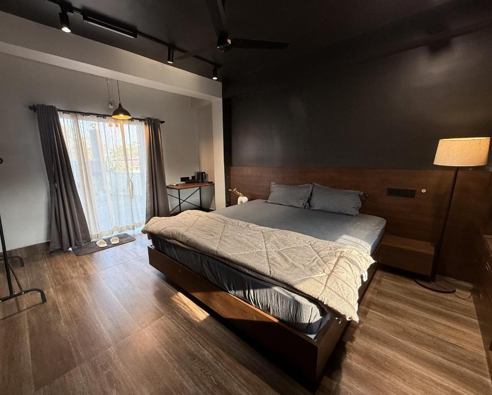 a bedroom with a bed and a large window at Terrace By Opal in Barābhīta