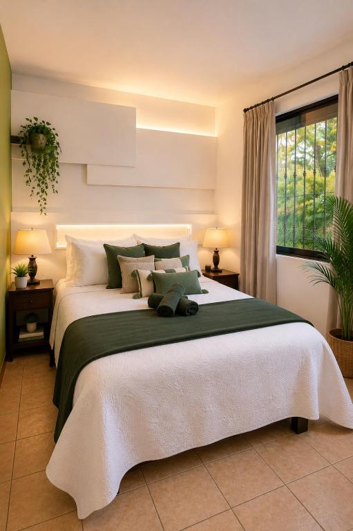 a bedroom with a large bed and a window at Morada Luna Coyoacán in Mexico City
