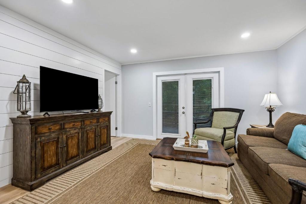 a living room with a flat screen tv and a couch at 8A Amelia Landings Condo in Fernandina Beach