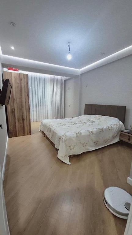 a bedroom with a large bed in the middle of it at Jasmin Park in Baku