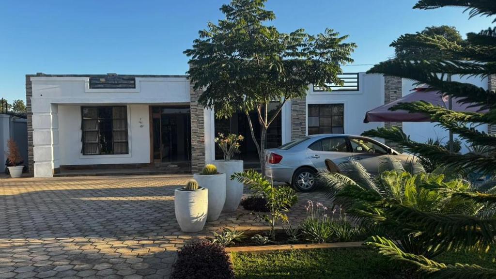 a car parked in front of a building at Kulala Holiday Home Livingstone in Livingstone