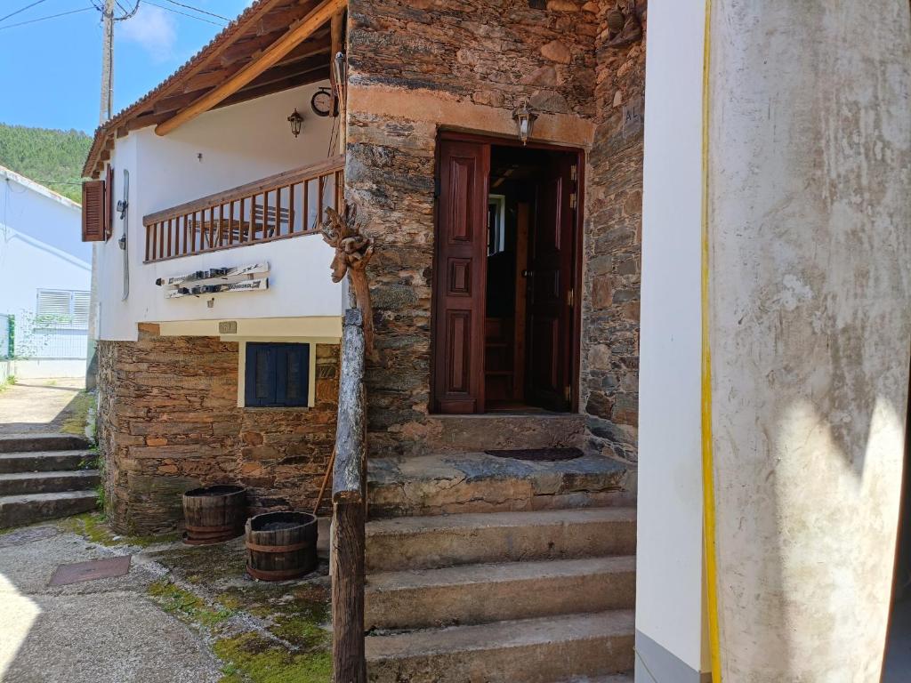 a house with stairs leading up to a door at Casa do Baloiço em Porto de Vacas Aldeias de Xisto in Janeiro de Baixo