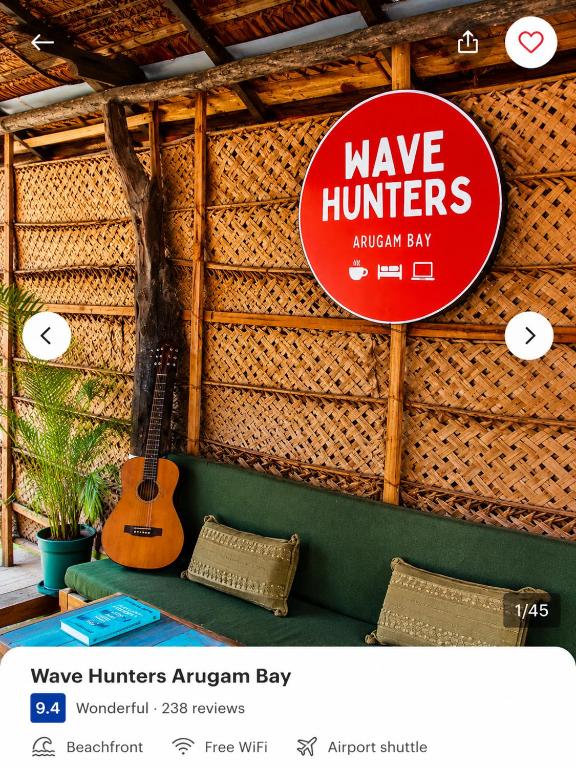 a sign that says wave hunters american bay with a guitar at Wave Hunters Arugam Bay in Arugam Bay