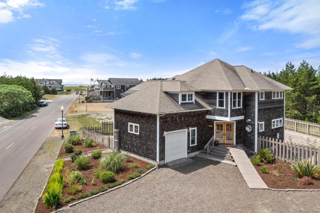 a brick house with a fence and a driveway at Here Comes the Sun 3 min to Beach, Fire Pit in Long Beach