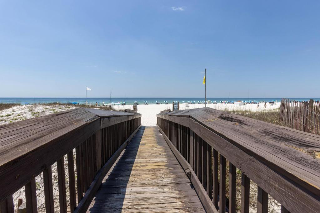 a boardwalk to the beach with the ocean in the background at Harbour Place 510 in Gulf Shores