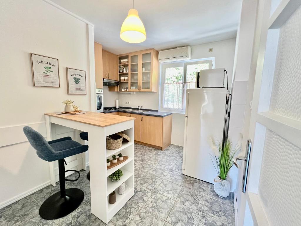 a kitchen with a desk and a refrigerator at Rab City Apartment Greeny in Rab