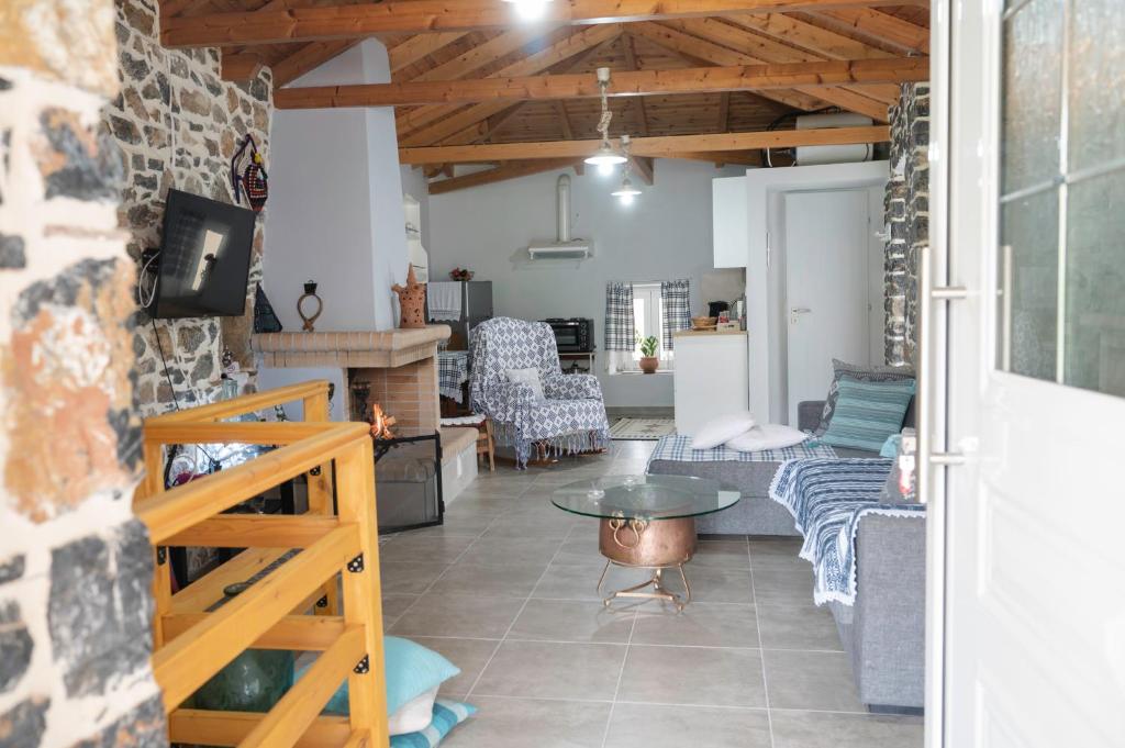 a living room with a couch and a table at Πέτρινο Αλώνι in Panayía