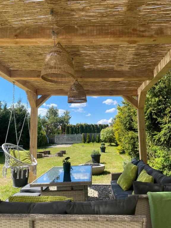 a patio with a wooden pergola at Camping Abordaż Wolin in Kołczewo