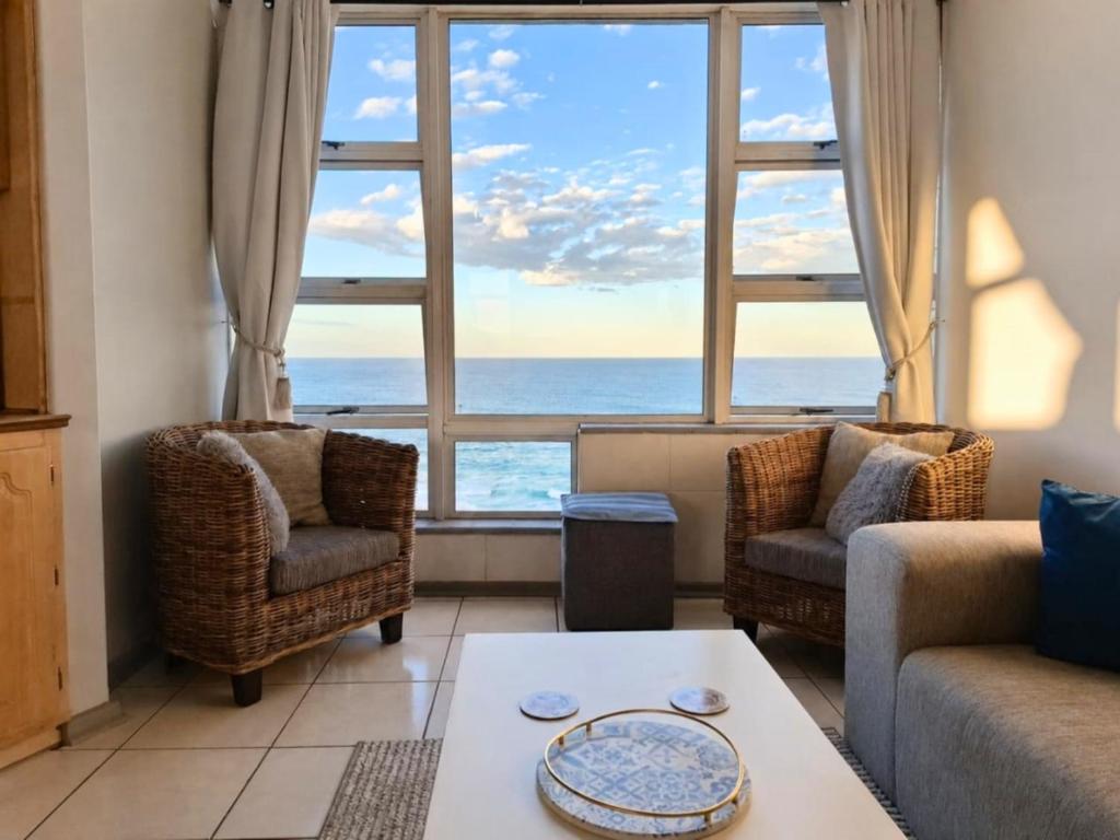 a living room with a view of the ocean at Scottburgh Views 707 Seafront Apartment in Scottburgh