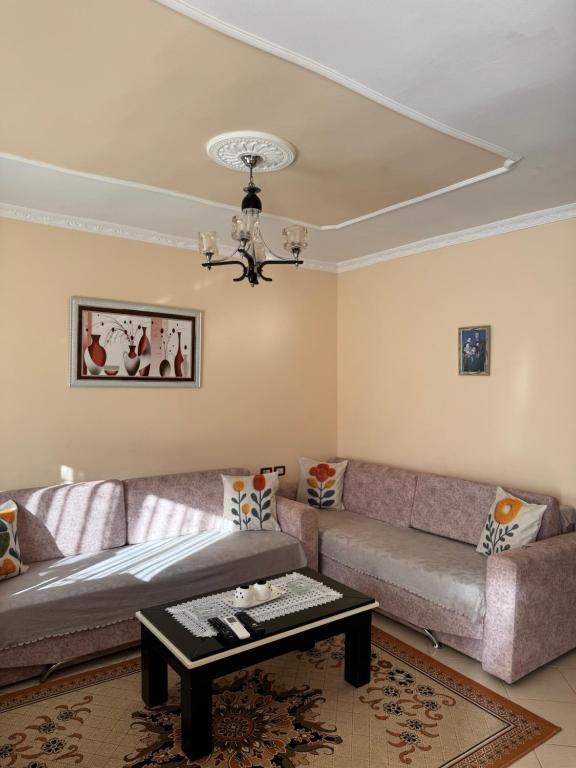 a living room with a couch and a table at Guest House Dimos Kristi in Përmet