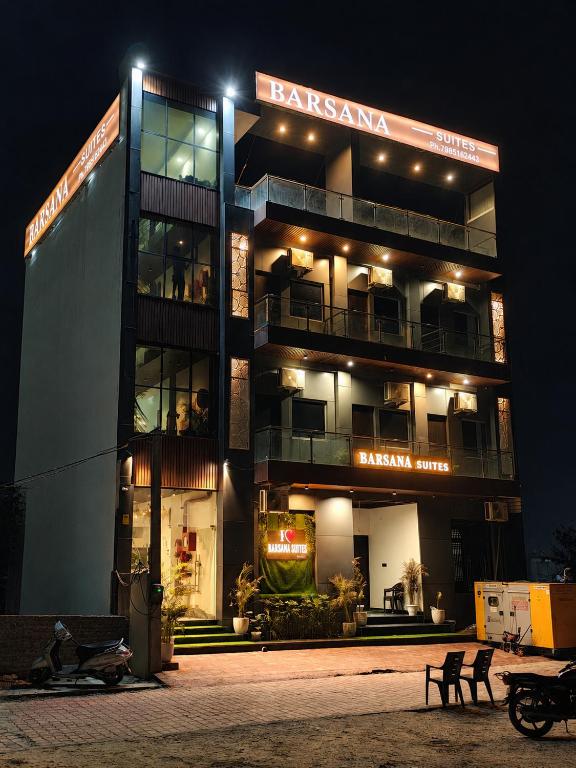 a building with a sign on the side of it at night at Barsana Suites in Vrindāvan