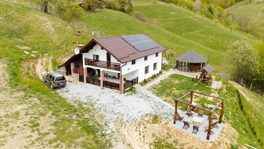 an aerial view of a house with a solar roof at Cabana Colț de liniste in Feldru