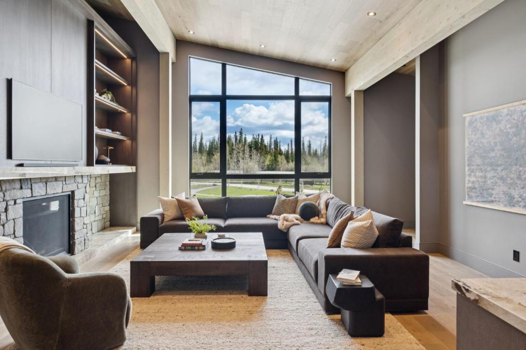 a living room with a couch and a fireplace at Sisu Lodge by Canmore Premier in Kananaskis Village