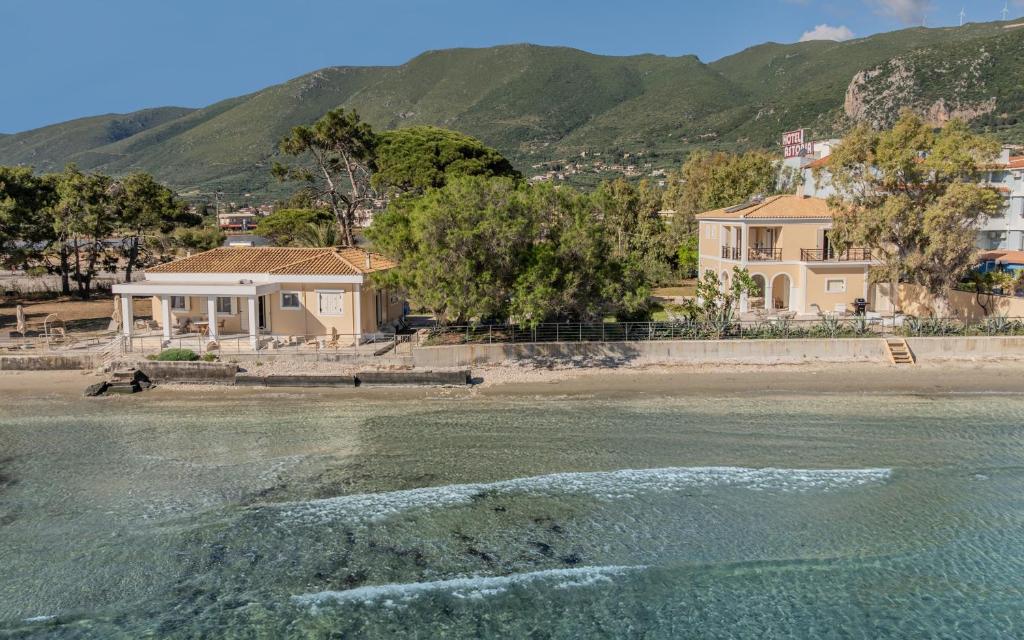 a house on the shore of a beach at Sandy Pines Villas in Alykes