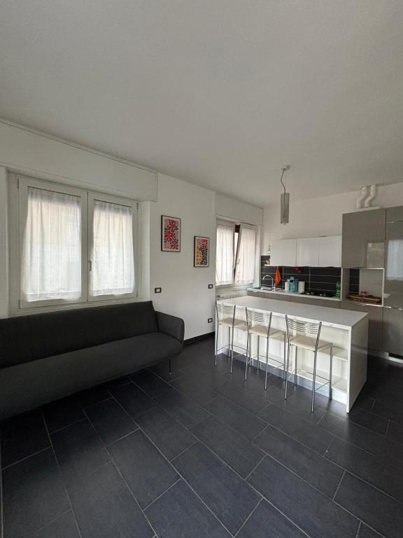 a living room with a couch and a kitchen at Gerenz-home in Lecco