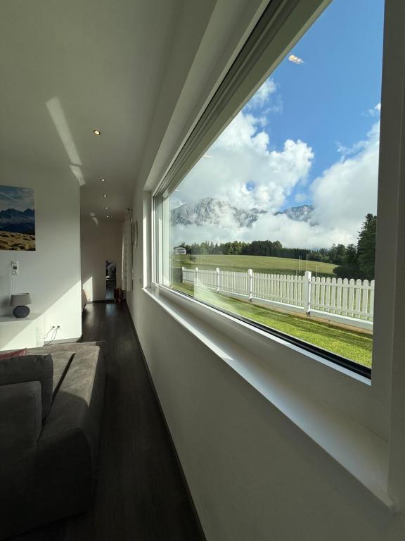 a room with a large window with a view of a fence at Apartment Spitzenblick in Angerberg