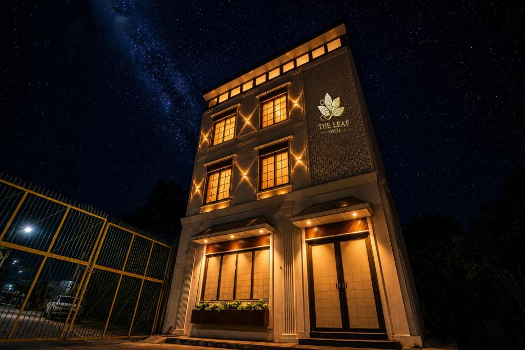 a building with a sign on it at night at The Leaf in Ludhiana