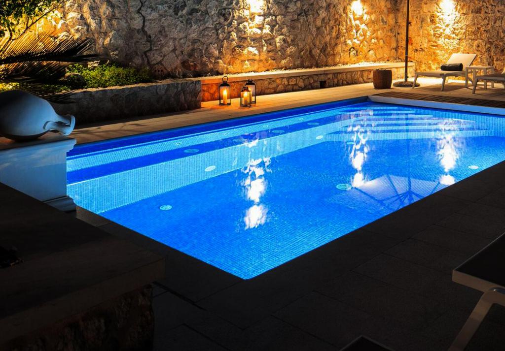 a swimming pool at night with lights at Old Town Oasis in Dubrovnik