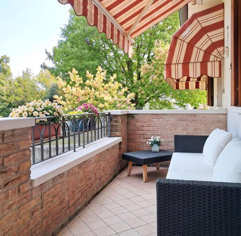 a patio with a white couch and a balcony at Casa Il Sogno in Vazzola