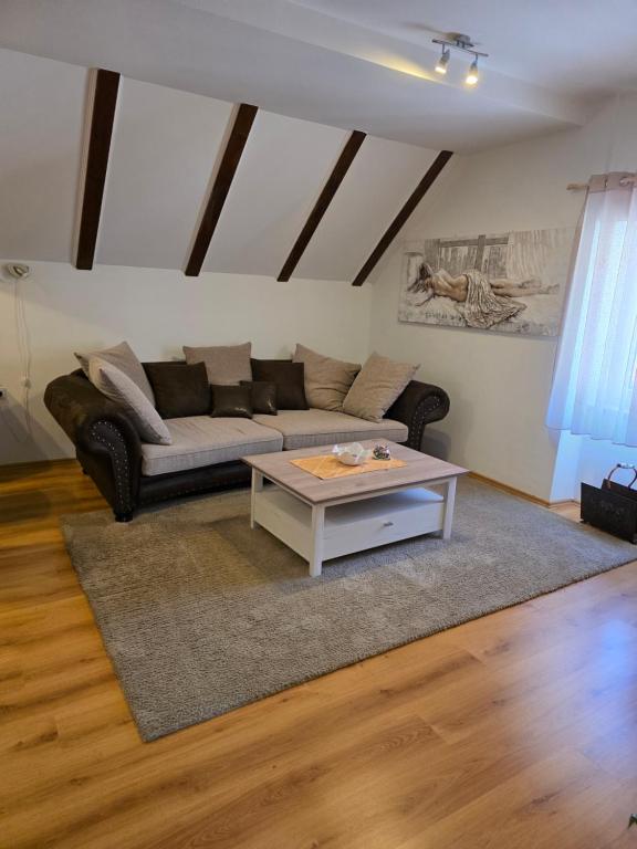 a living room with a couch and a coffee table at Apartman Gorski raj in Fužine