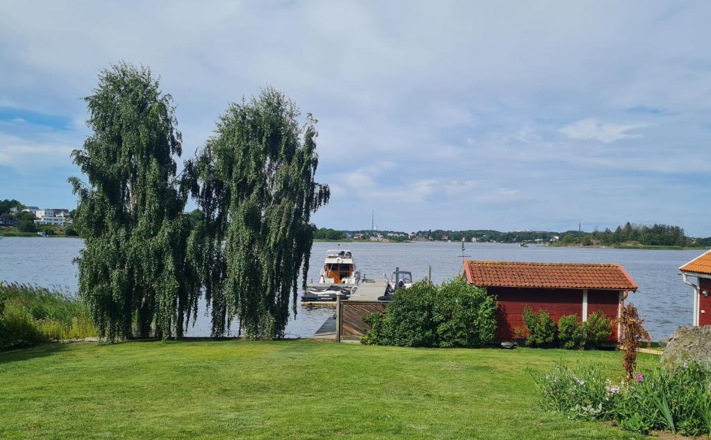 a house and a boat on the water at Ellas Brygga in Karlskrona