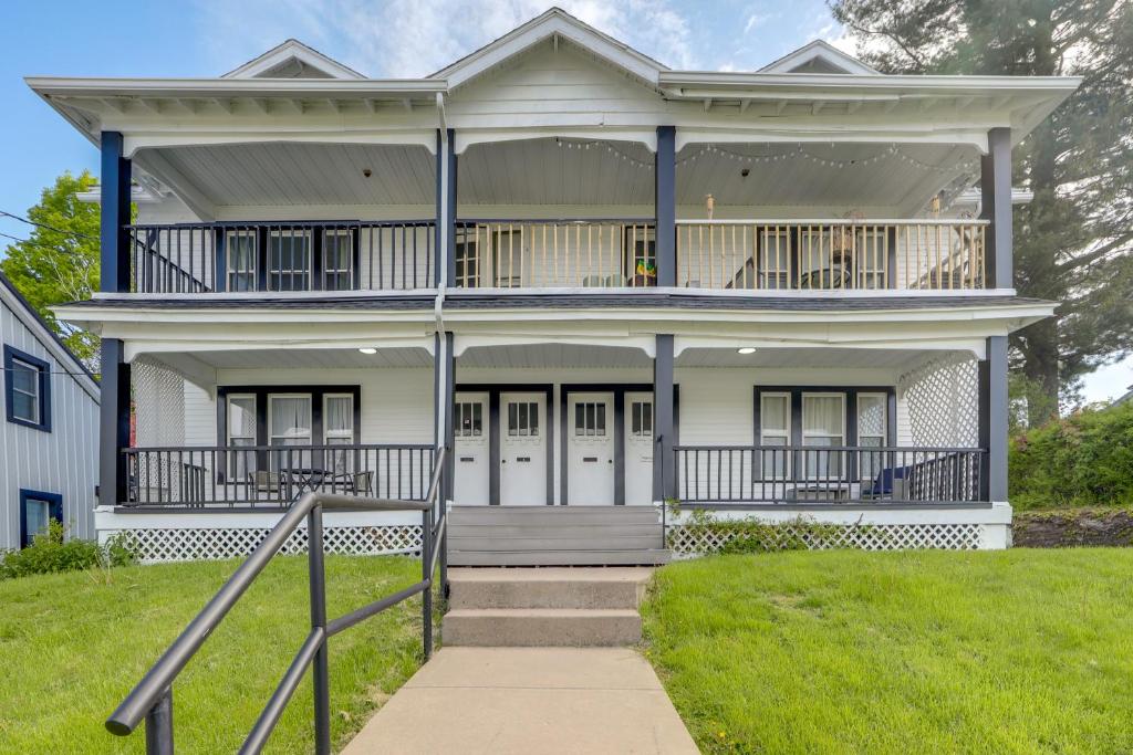 a large white house with a balcony at Walkable 3-Unit Hub: 8 Mi to Micron Technology! in Phoenix