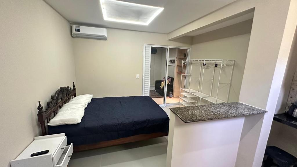 a bedroom with a bed and a walk in shower at Mini apê de luxo montese in Fortaleza