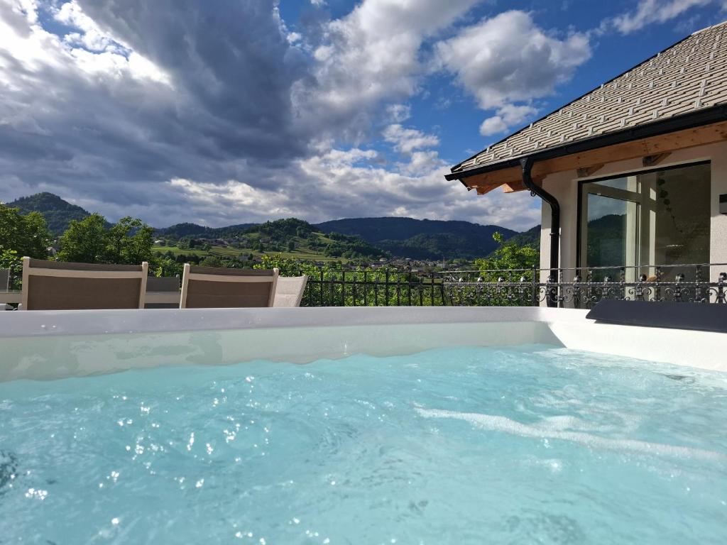 a swimming pool with a view of the mountains at Murka Holiday Home in Bled