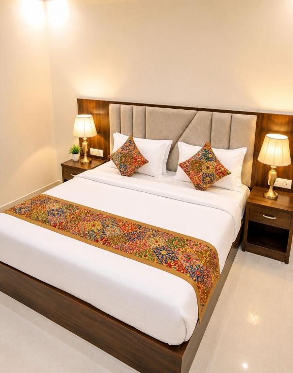 a bedroom with a large bed with two lamps at Hotel Urban Inn - The RK Hospitality Group #Prem Mandir #Chaar Dham Fully AC in Vrindāvan