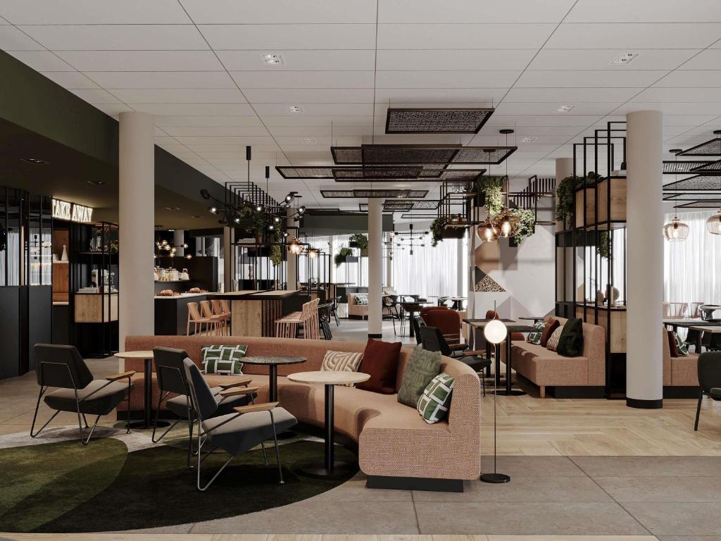 a lobby with couches and tables and chairs at ibis Konstanz in Konstanz