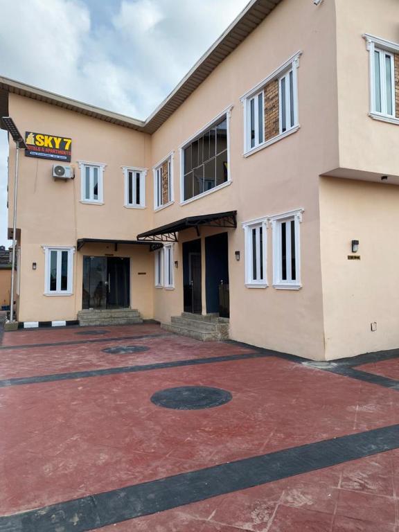 an empty parking lot in front of a building at sky 7 hotel & apartment in Akure
