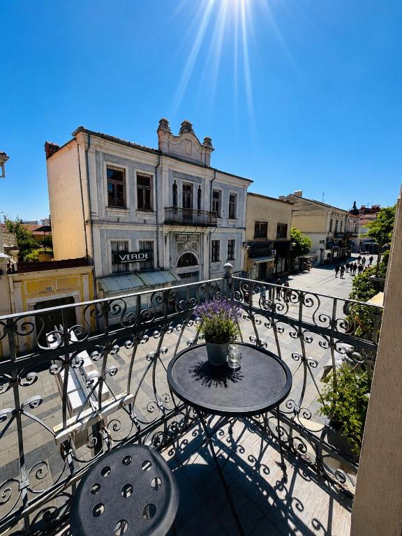 a patio with a table and chairs on a balcony at TASY Guest House - Luxury Rooms in the Heart od SHIROK SOKAK in Bitola