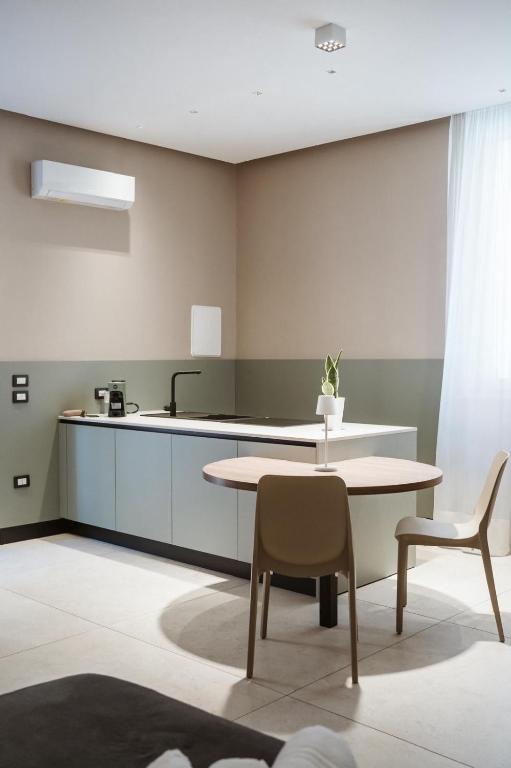 a kitchen with a table and two chairs and a counter at MEANDRI Apartment in San Severo