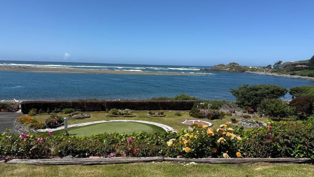 a golf course with a view of the ocean at Arky's B&B in Smith River