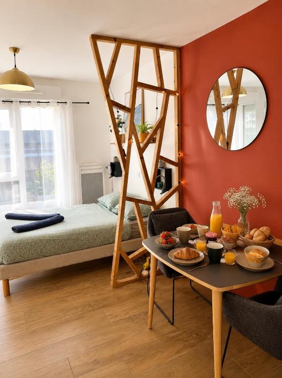 a bedroom with a bed and a table with food on it at Suite Sunset in Saint Malo
