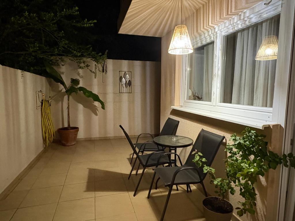 a room with chairs and a table and a window at Tara Apartment in Herceg-Novi