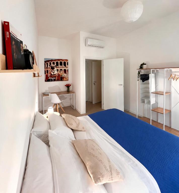 a bedroom with a large white bed with pillows at Al Carlino Verona in Verona