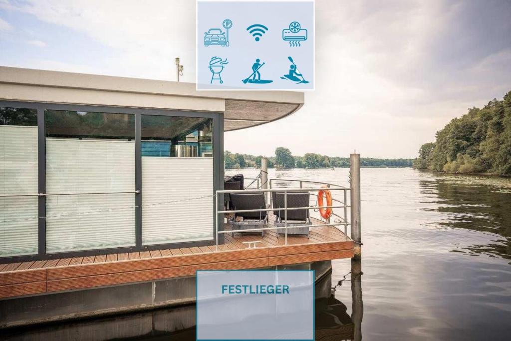 a boat on the water with a sign on it at Floatinghouse Nike in Hennigsdorf