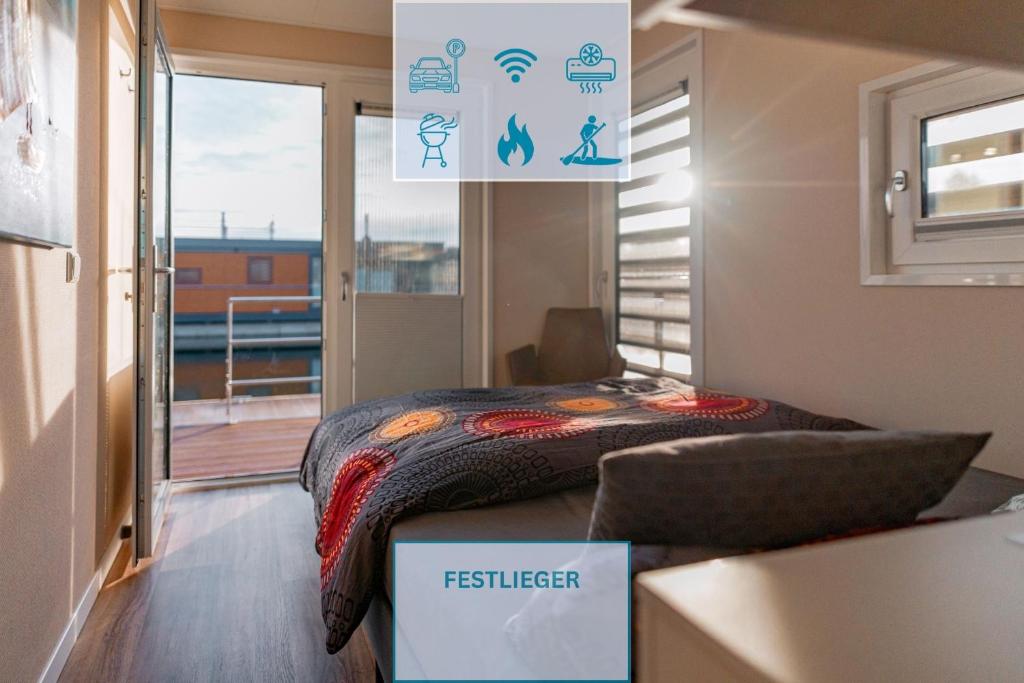 a small bedroom with a bed in a room with a balcony at Floatinghouse Paradise in Klitten