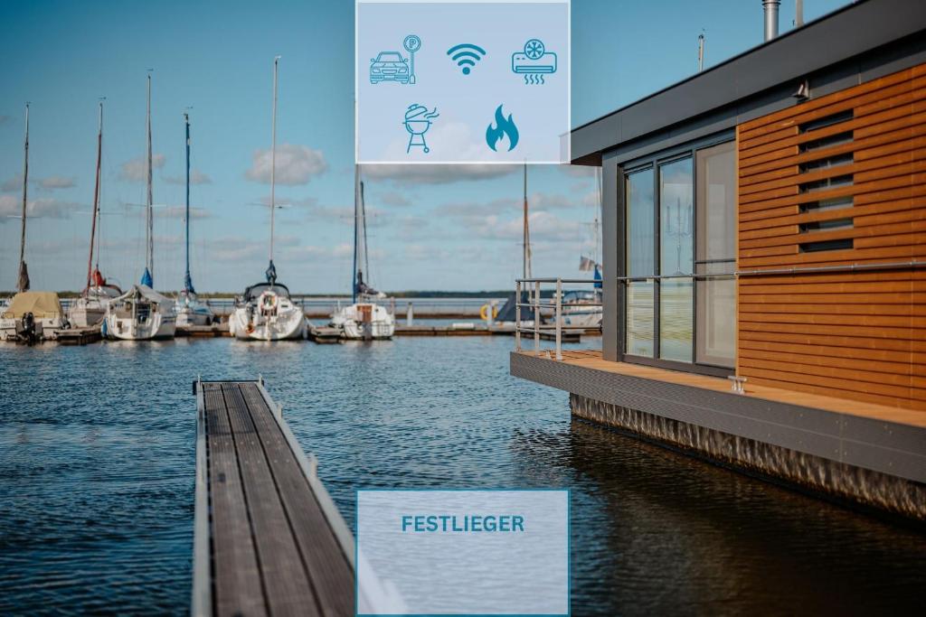 a dock with a marina with boats in the water at Floatinghouse Möwenschiss in Klitten