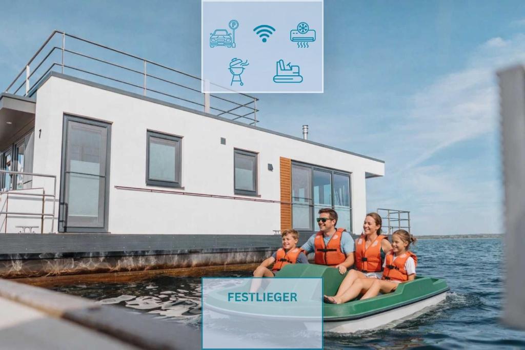 a group of people sitting on a boat in the water at Floatinghouse Neptun - LP3 in Vetschau