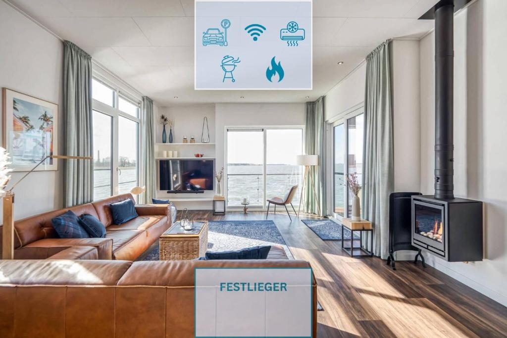 a living room with a couch and a fireplace at Floatinghouse Große Freiheit in Ribnitz-Damgarten