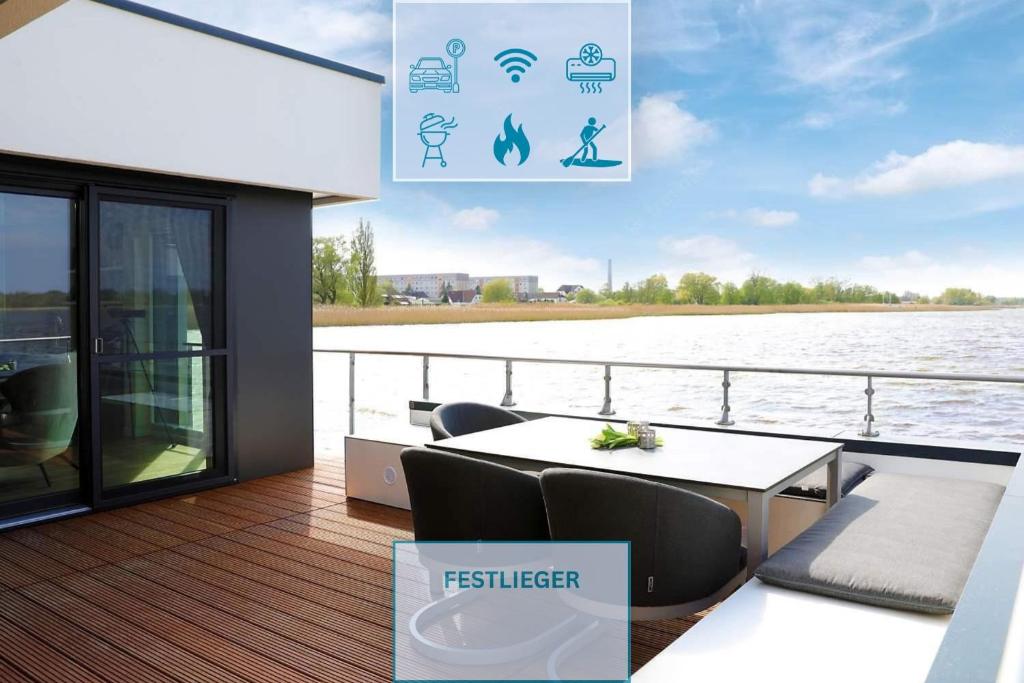 a deck of a boat with a table and chairs at Floatinghouse Bernstein Suite in Ribnitz-Damgarten