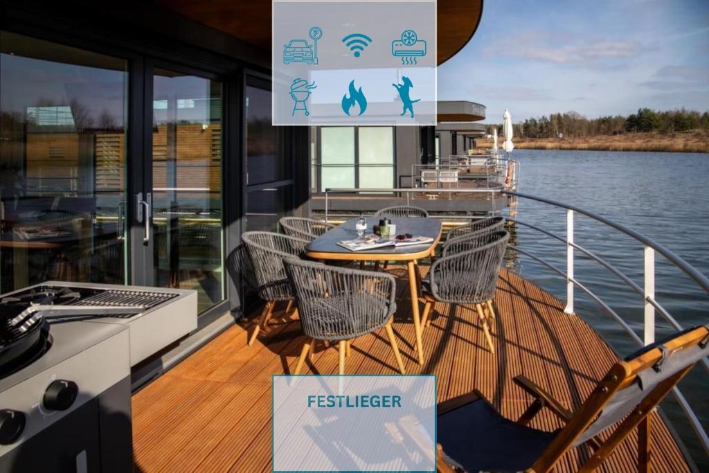 a deck of a boat with a table and chairs at Floatinghouse Bahama Mama in Klitten